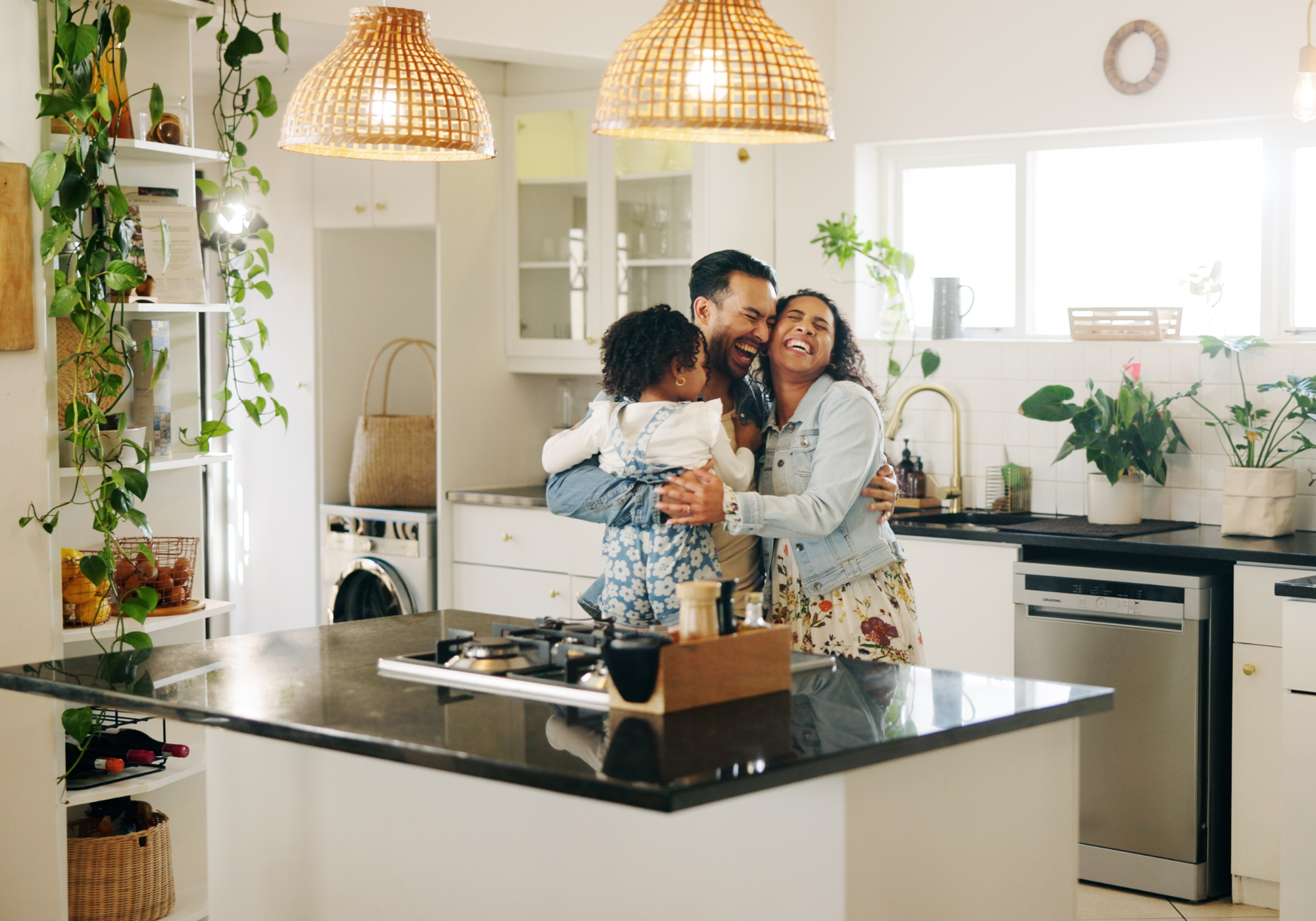 Happy family standing in newly remodeled kitchen. 