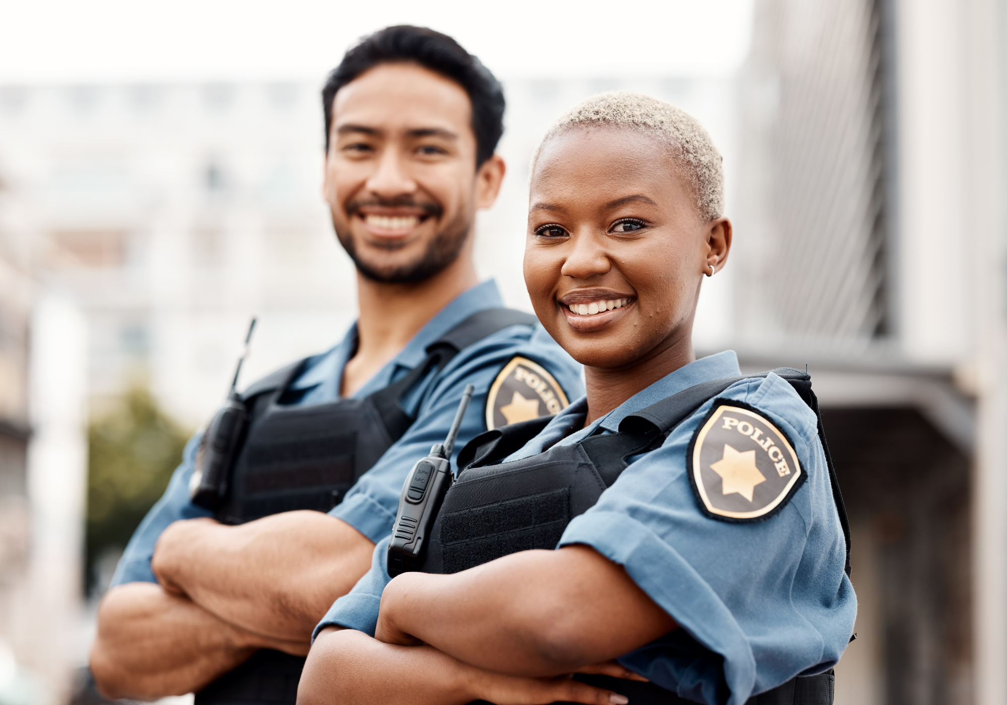 two police officers smiling standing together 