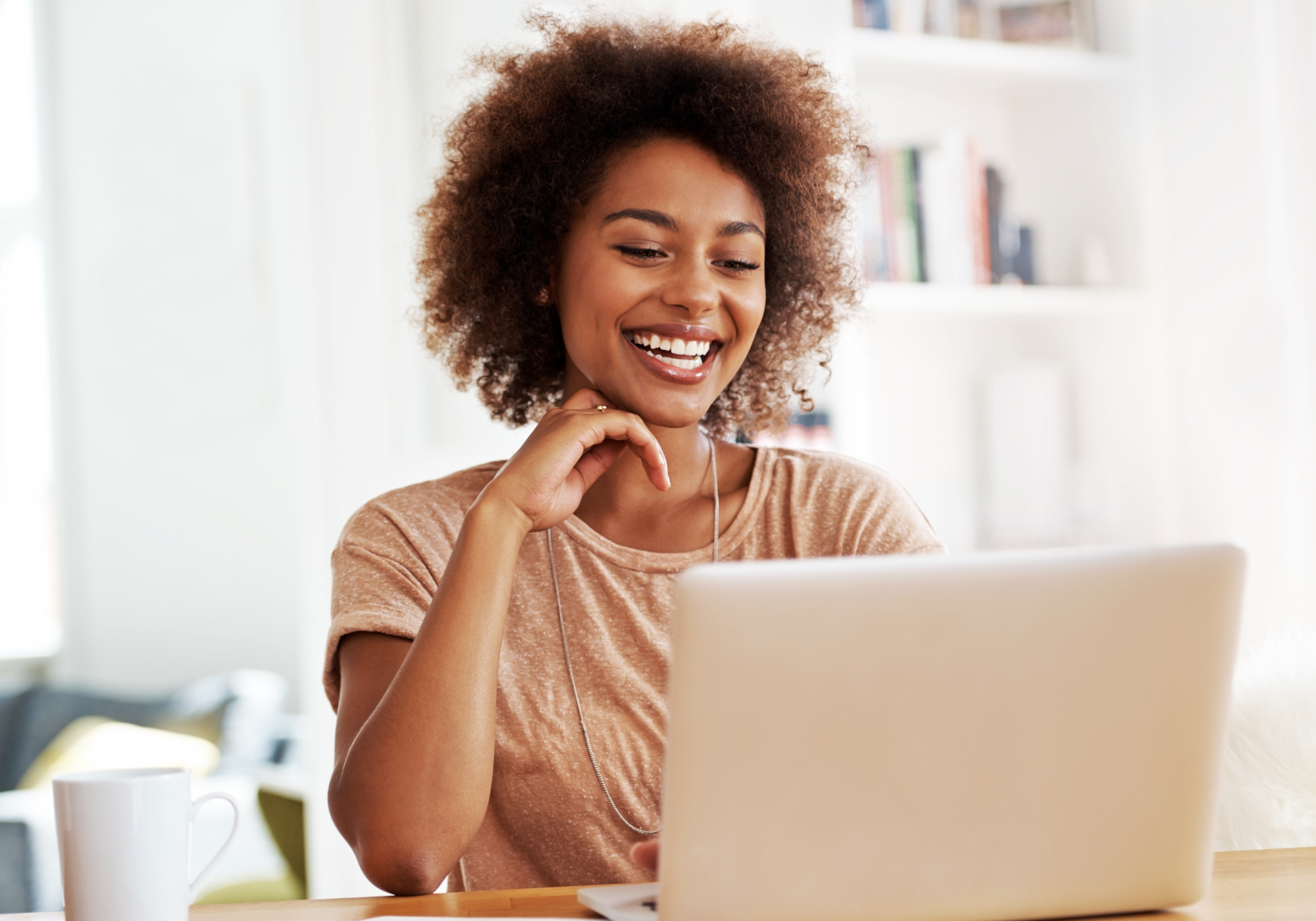 Woman reviewing The Police Credit Union Savings Account options online. 